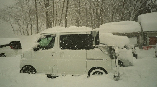 Kei van buried in deep snow during a powder day in rural Japan