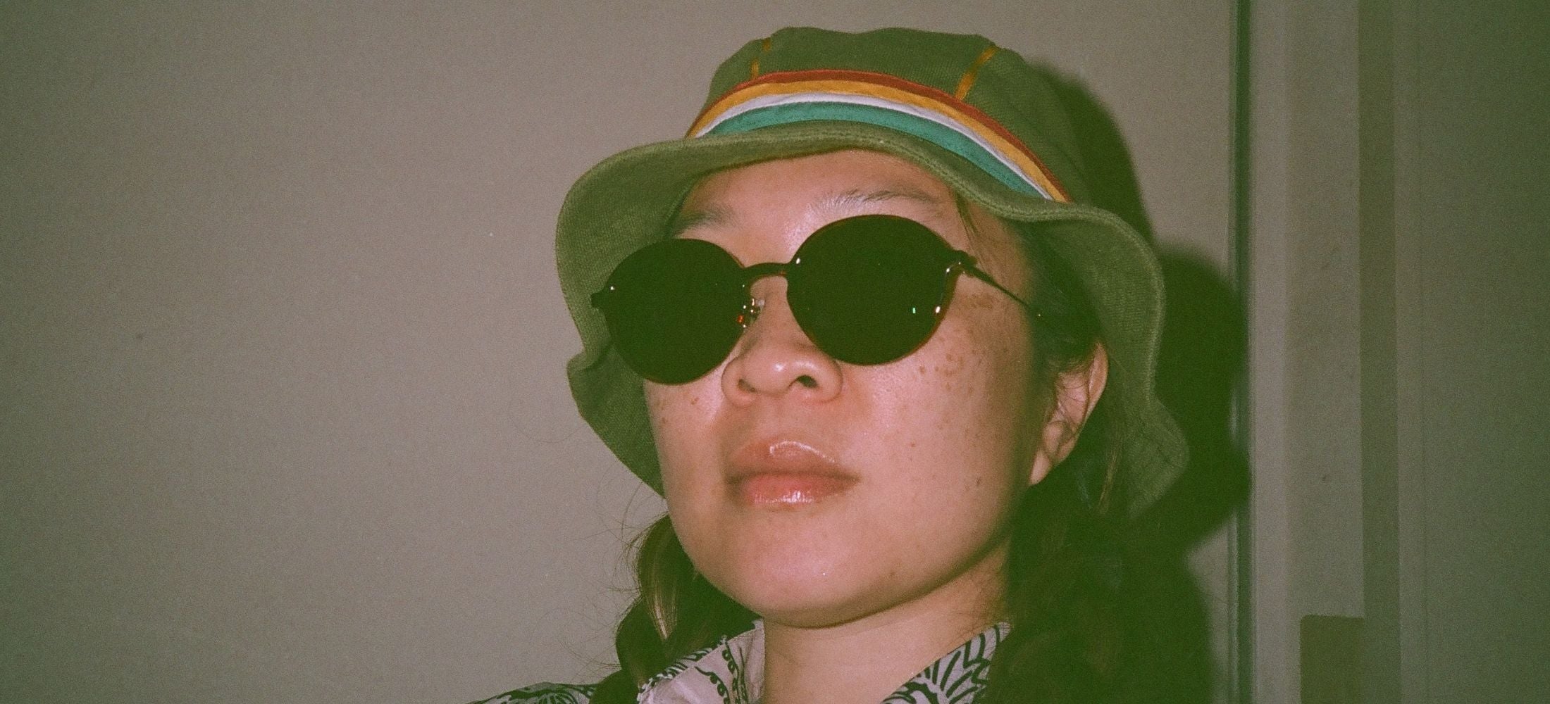 film photo of girl in sunglasses and hat