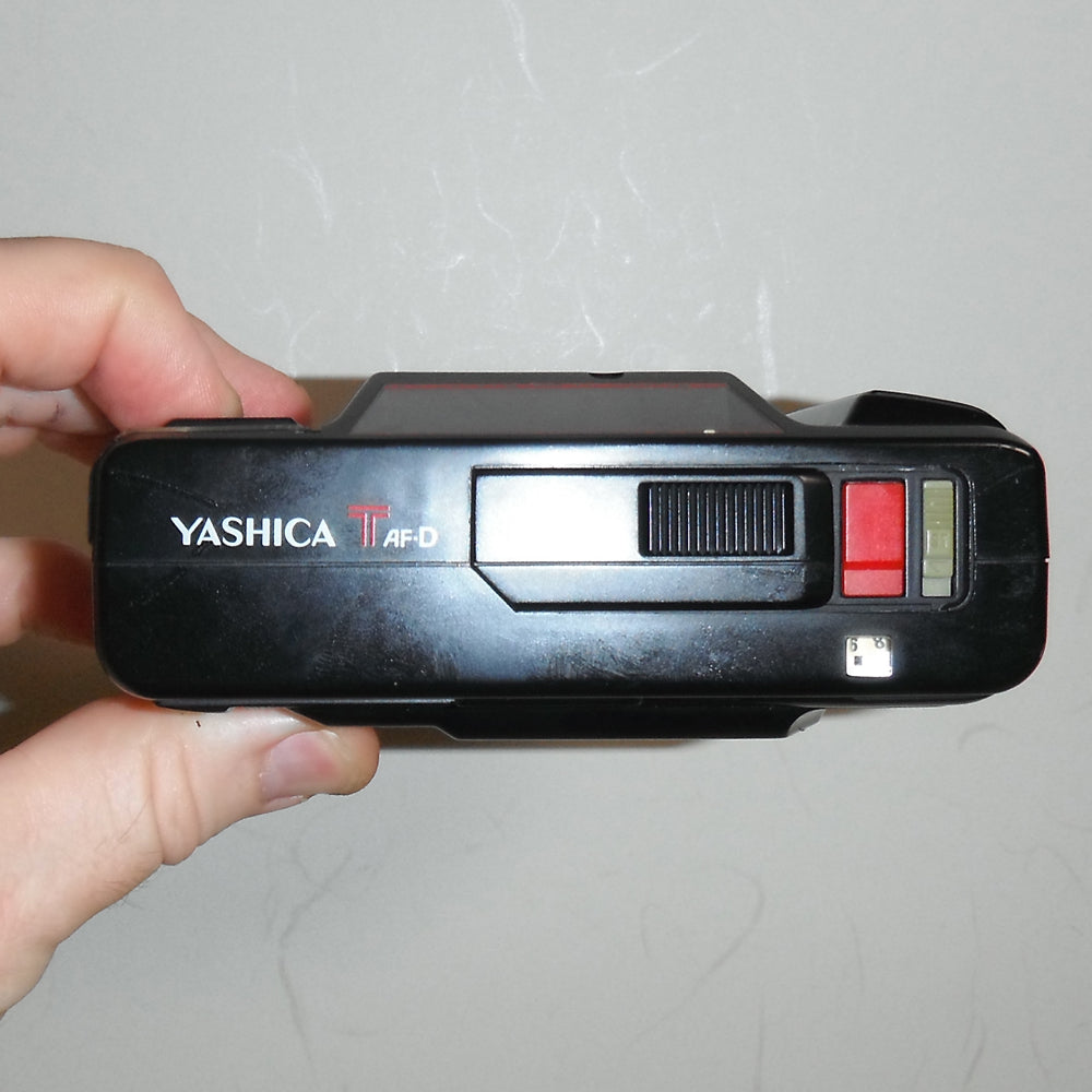Top-down angle showing shutter button, LCD, and flash toggle